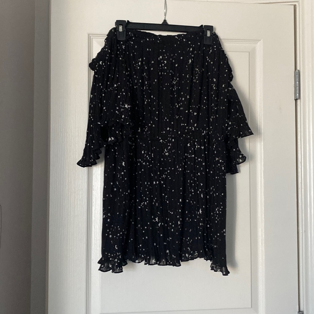 Black off the shoulder shirt. Has stars. Never worn